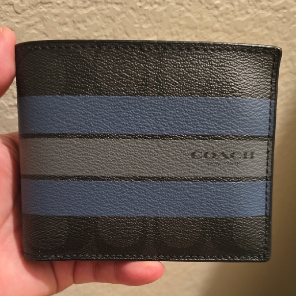 The pictured item is a Coach 3-in-1 Wallet in Signature Canvas w/ Varsity Strip